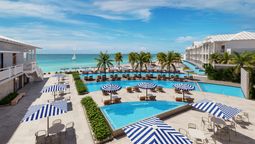 Representación de la piscina rediseñada de Sandals Montego Bay, con acceso directo a la playa. Se aprecia además las nuevas suites swim-up con ingreso desde la piscina.