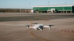 Un drone sobrevolando una pista de un aeropuerto.